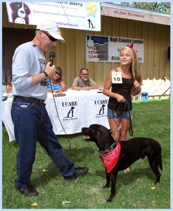 Ted Schade interviewing Alicia Ramirez with Trace, her adopted 3-legged dog - 1st Place Outstanding Adopted Pet — at Tri-County Fairgrounds.