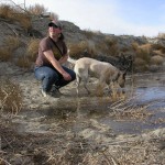 Phoebe Prather and Jake greet the first trickle of water in the Lower Owens River in November of 2006, when water was returned to the formerly dry streambed. Note the tumbleweeds, dead trees and bone dry riverbed. Today, water has brought new life to 62 miles of the Lower Owens River. Photo by Mike Prather. 