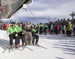 (second from left) MMSA CEO Rusty Gregory, seated next to Woolly, opens the mountain.