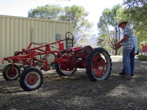 Bishop Creek Farm operator Steve Baldwin explains his newly converted electric tractor which allows him and his farming partner Bruce Willey to work more land while producing virtually no direct engine emissions.