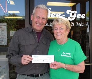Ted Schade, ICARE President accepts donation from Becky Parham, owner of Bee Gee Beauty Supply (photo by Lisa Schade)