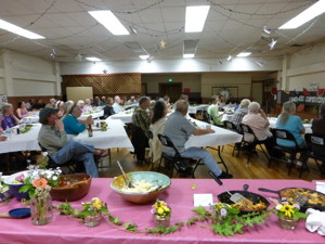 About 50 people gathered in the Independence Legion Hall and enjoyed a light meal featuring locally grown produce, locally made baked goods and homemade entrees. Members of the Owens Valley Growers Cooperative presented their plans to reopen Mair’s Market in Independence. Photo by Tamara Cohn.   