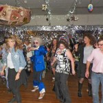 Inyo Supervisor Jeff Griffiths showing his moves on the floor as giant fruitcake threatens to crush other dancers