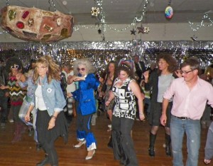 Inyo Supervisor Jeff Griffiths showing his moves on the floor as giant fruitcake threatens to crush other dancers Custom