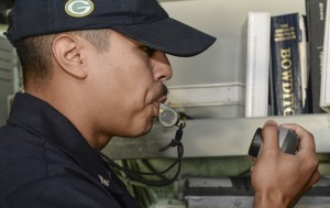 150730-N-TW634-026 DARWIN, Australia (July 30, 2015) Boatswain’s Mate 3rd Class Emmanuel Castro, from Lone Pine, Calif., blows a whistle into the 1 main circuit (1MC), or general announcing system, of the amphibious transport dock ship USS Green Bay (LPD 20) to signal the end of colors to the ship’s crew. Green Bay is assigned to the Bonhomme Richard Expeditionary Strike Group and is on patrol in the U.S. 7th Fleet area of operations (U.S. Navy photo by Mass Communication Specialist 3rd Class Derek A. Harkins/Released)