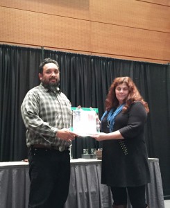 Ron Napoles receives the award from Brianna Candelaria, BLM National Lead for Interpretation