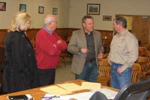 New Southern Inyo Healthcare District board members Jaque Hickman, Richard Fedchenko and Mark Lacey, following their official swearing in at Tuesday's special Board of Supervisors meeting, are hopefully getting a pep talk from Inyo's County Executive Officer Kevin Carunchio. 