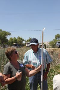 Paula Escaufedo, head of the site visit from the Department of Natural Resources, and Randy Short get a look at the tule tool. 