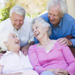 four older people laughing
