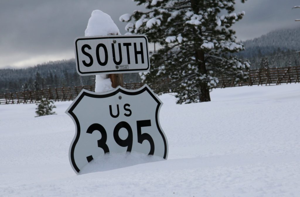 395 hwy sign buried in snow