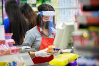 grocery store cashier wearing masks and face shield